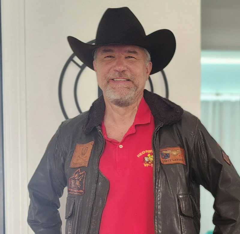 Bill Lefty Lawrence in a cowboy hat and Red Rippers jacket