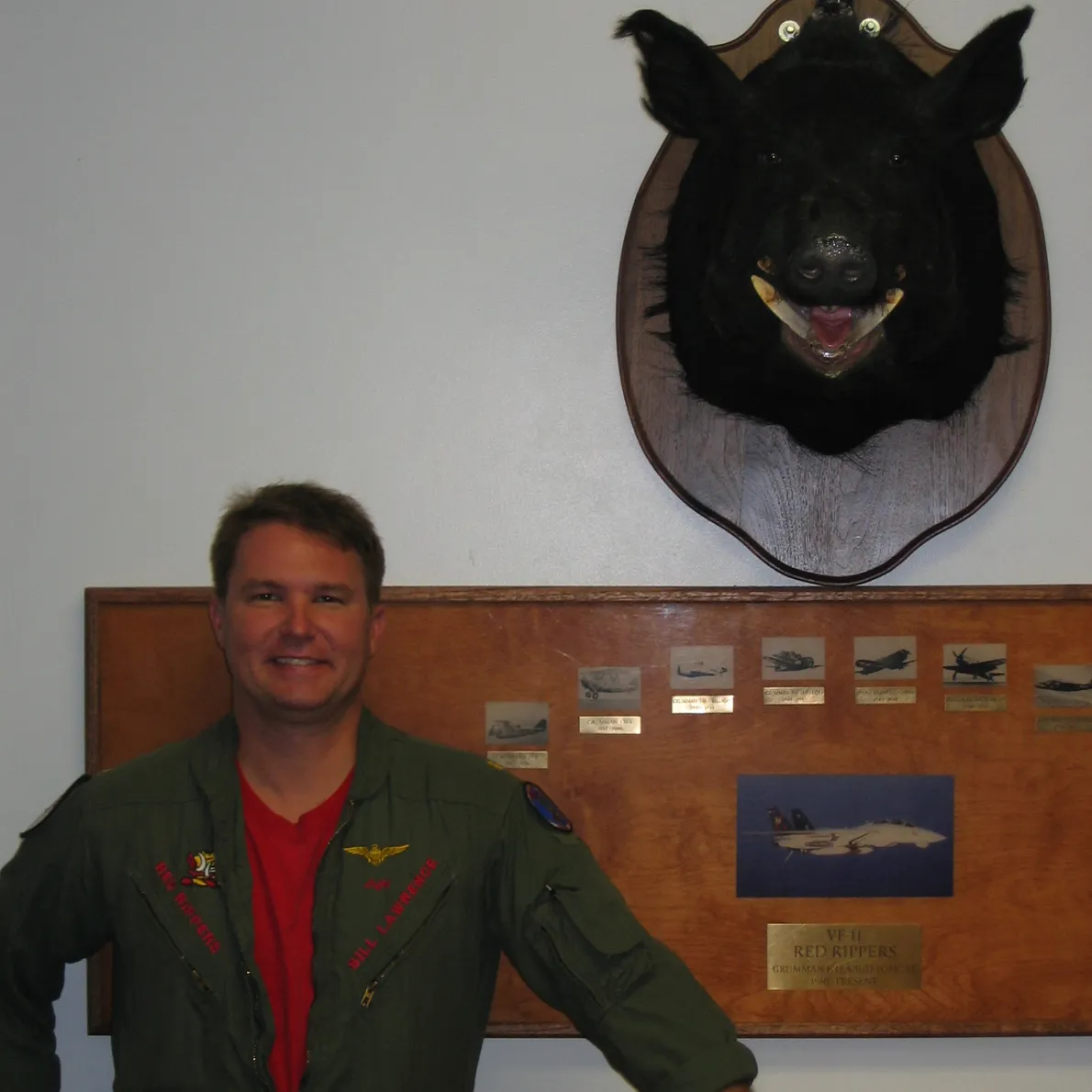 Bill Lefty Lawrence in a VF-11 Red Rippers flight suit with Arnold the wild boar