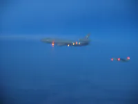 RIPPER 201 (162912) with GBU-31 in belly at sunset with USAF KC-10 Tanker