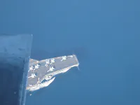 The bow of USS George Washington beneath an F-14 intake.