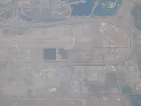Large airfield/airport complex, runway, taxiways, support buildings and nearby water/industrial areas