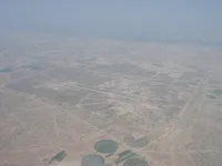 Military airfield with long runway, taxiways, support areas and extensive surrounding development