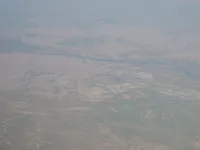 Airfield adjacent to dense city and major river