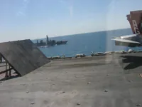 HMS Grafton (F80), Royal Navy Type 23 frigate behind Catapult 4 Jet Blast Deflector (JBD), VFA-131 AG-400 CAG Bird on Cat 4