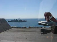 HMS Grafton (F80), Royal Navy Type 23 frigate behind Catapult 4 Jet Blast Deflector (JBD), VFA-131 AG-400 CAG Bird on Cat 4