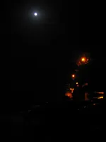 USS George Washington (CVN-73) at night under a full moon