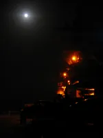 USS George Washington (CVN-73) at night under a full moon