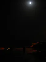 USS George Washington (CVN-73) at night under a full moon