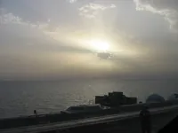 Sunset behind the clouds over the CVN-73 IFLOLS, approaching Catapult 3