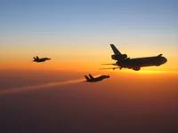 RIPPER 200 (163227) with 2x GBU-16s plugging on KC-10A Extender tanker serial 79-1713 with F/A-18C waiting; stream of gas from improperly seated probe