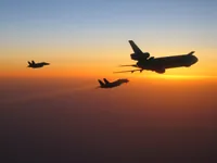 RIPPER 200 (163227) with 2x GBU-16s plugging on KC-10A Extender tanker serial 79-1713 with F/A-18C waiting; stream of gas from improperly seated probe